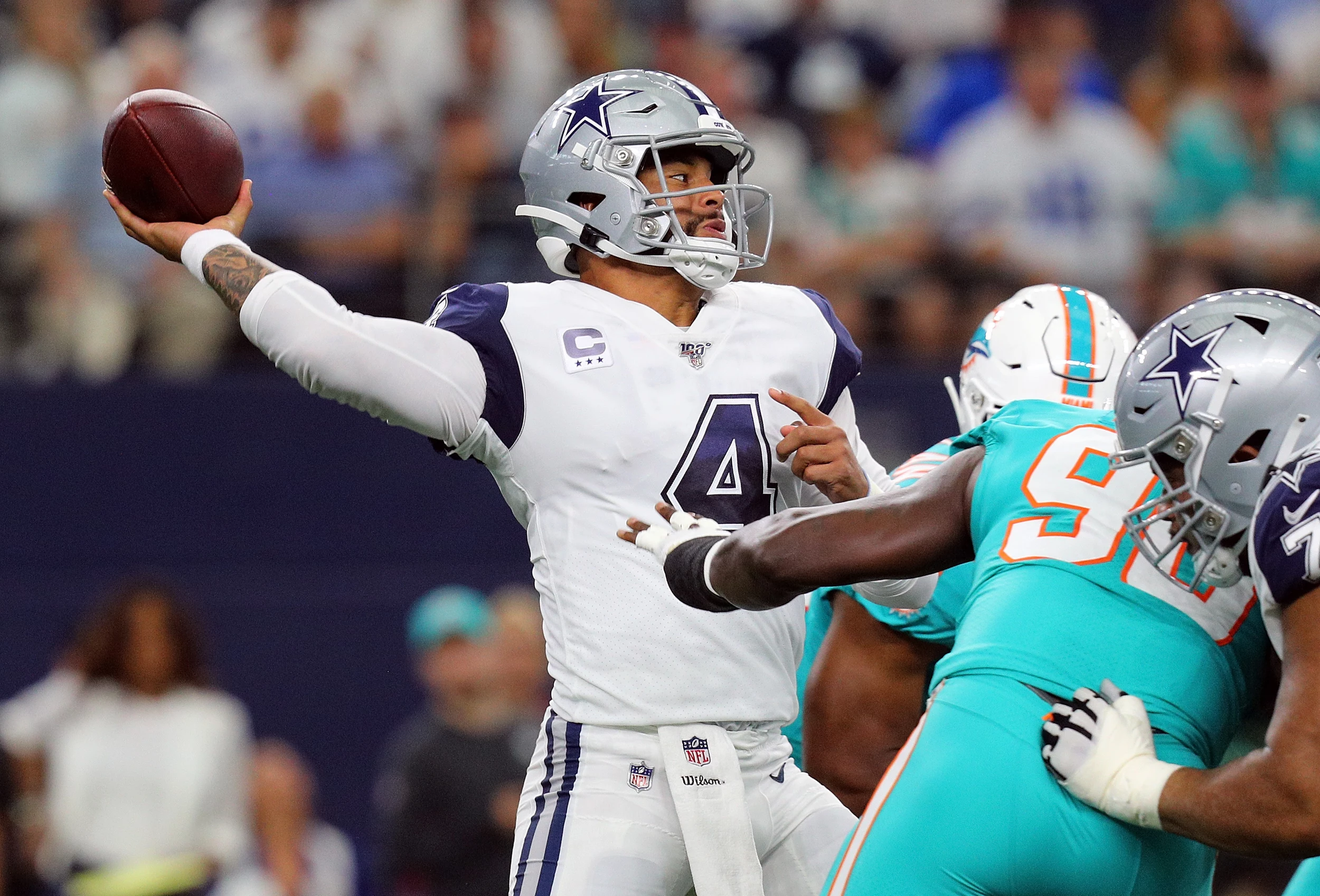 Dallas Cowboys quarterback Dak Prescott (4) in the huddle while on