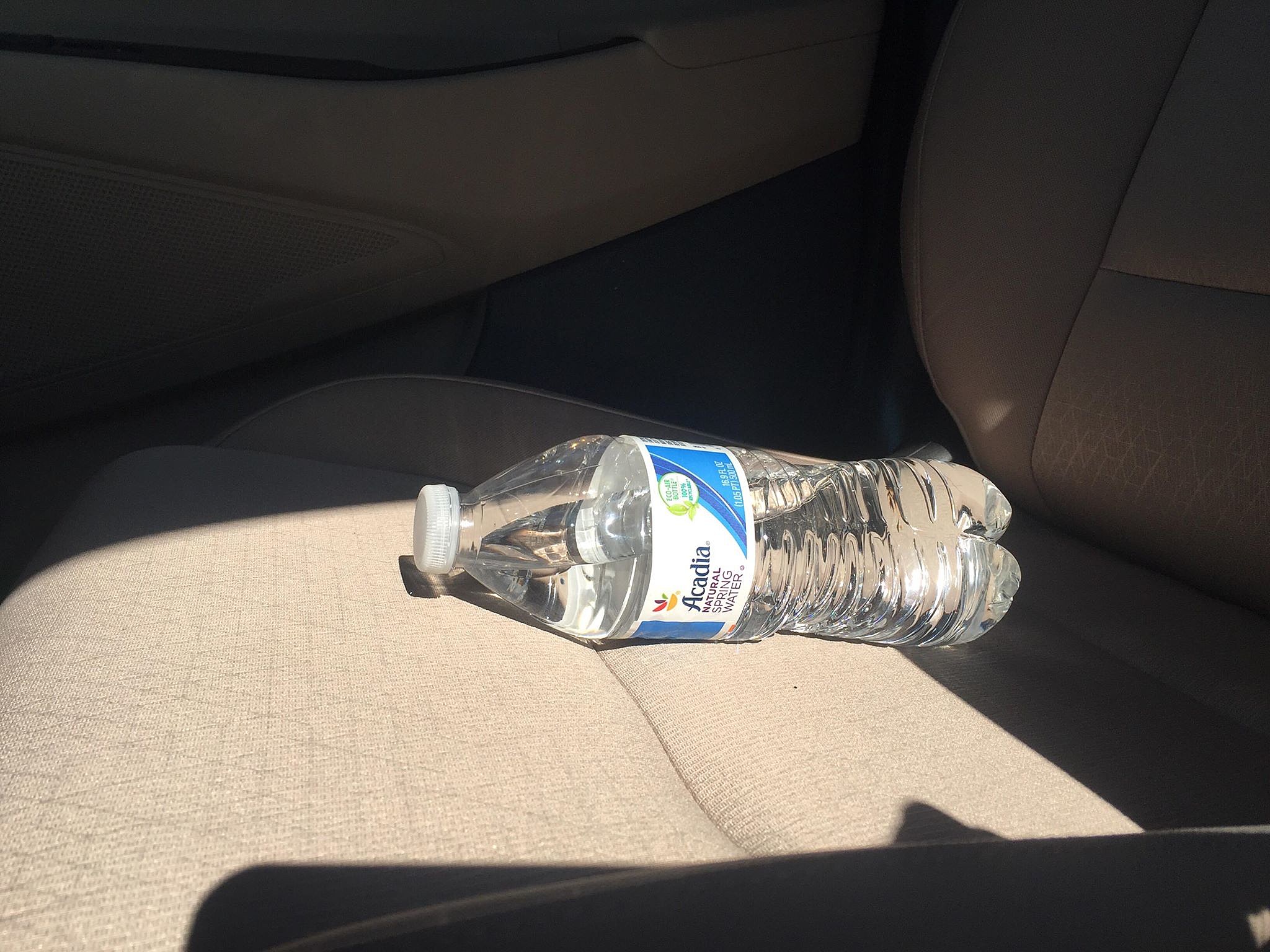 Image result for water bottle in car