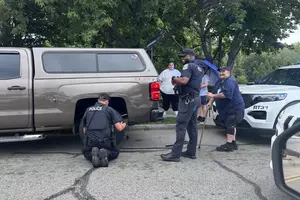 New Bedford Police Officers Stop to Help Stranded Driver Change Flat Tire