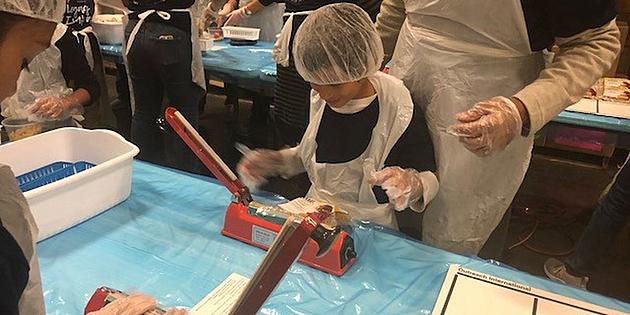 CCFCU Celebrates 60th Anniversary By Packing Meals For Needy Children