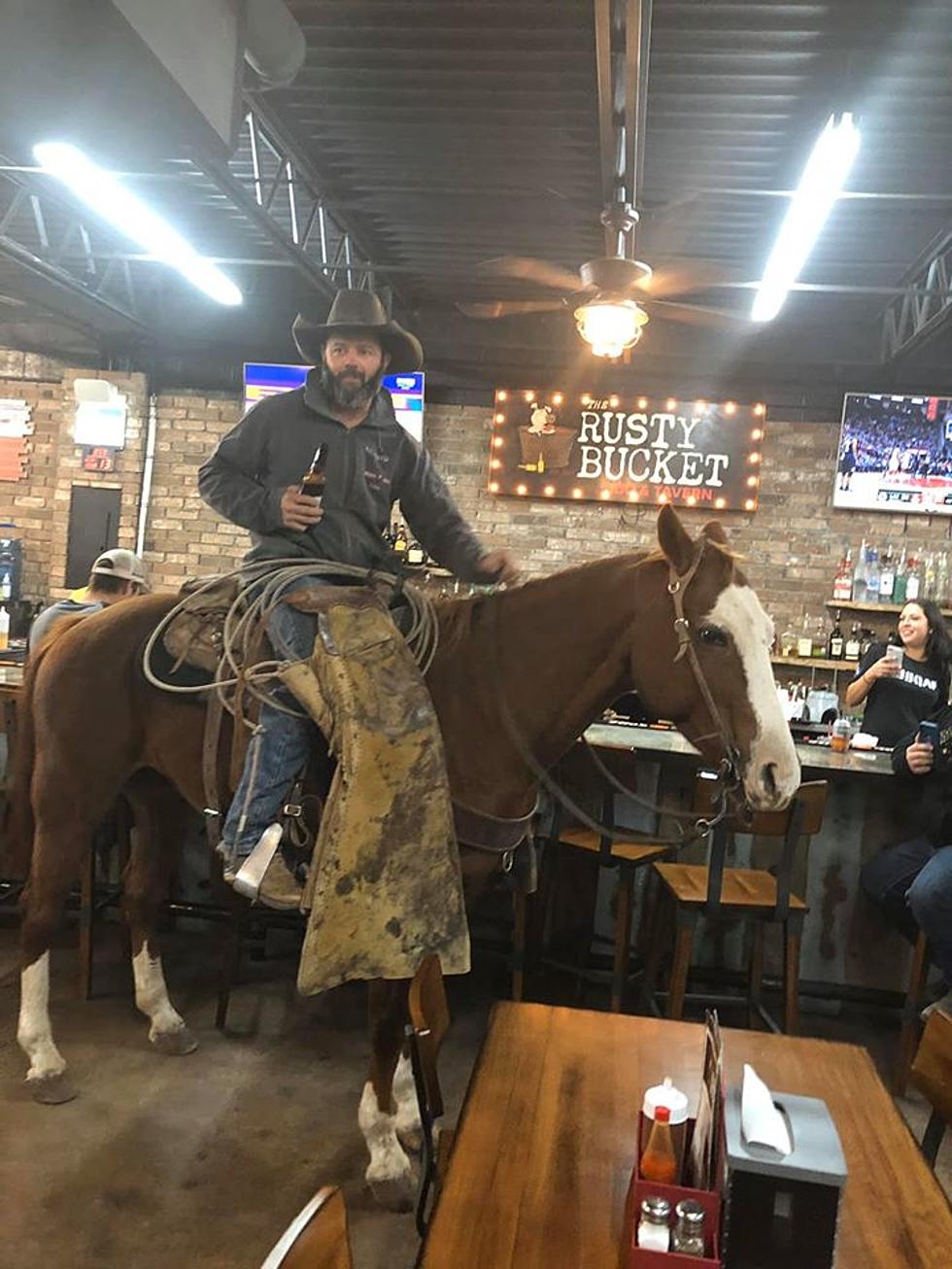 Man Rides Horse Into The Rusty Bucket In Midland
