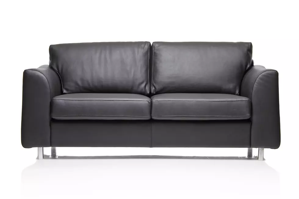 A modern black leather sofa isolated on a white background