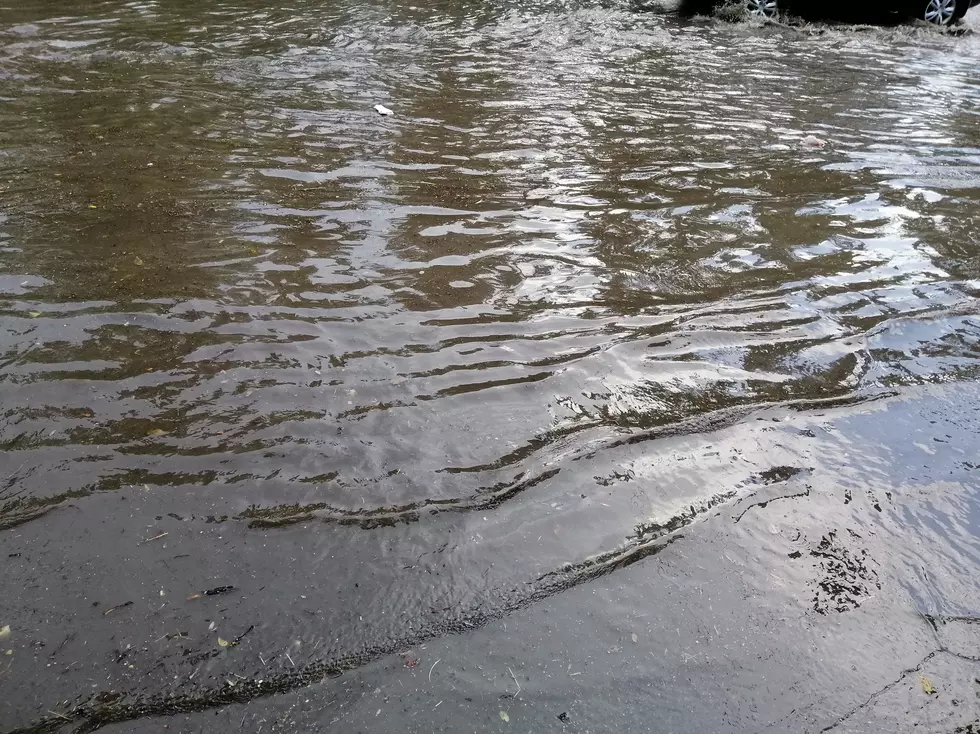 Large rain puddle on city street.