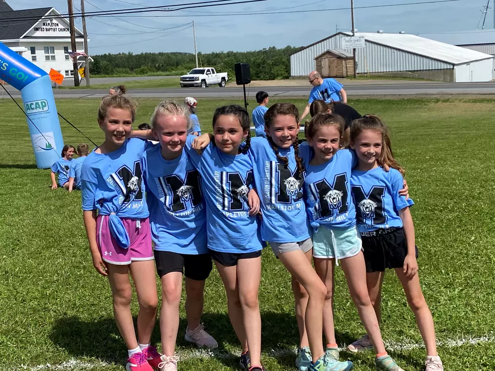 A group of friends at the finish line of the Mapleton Mile