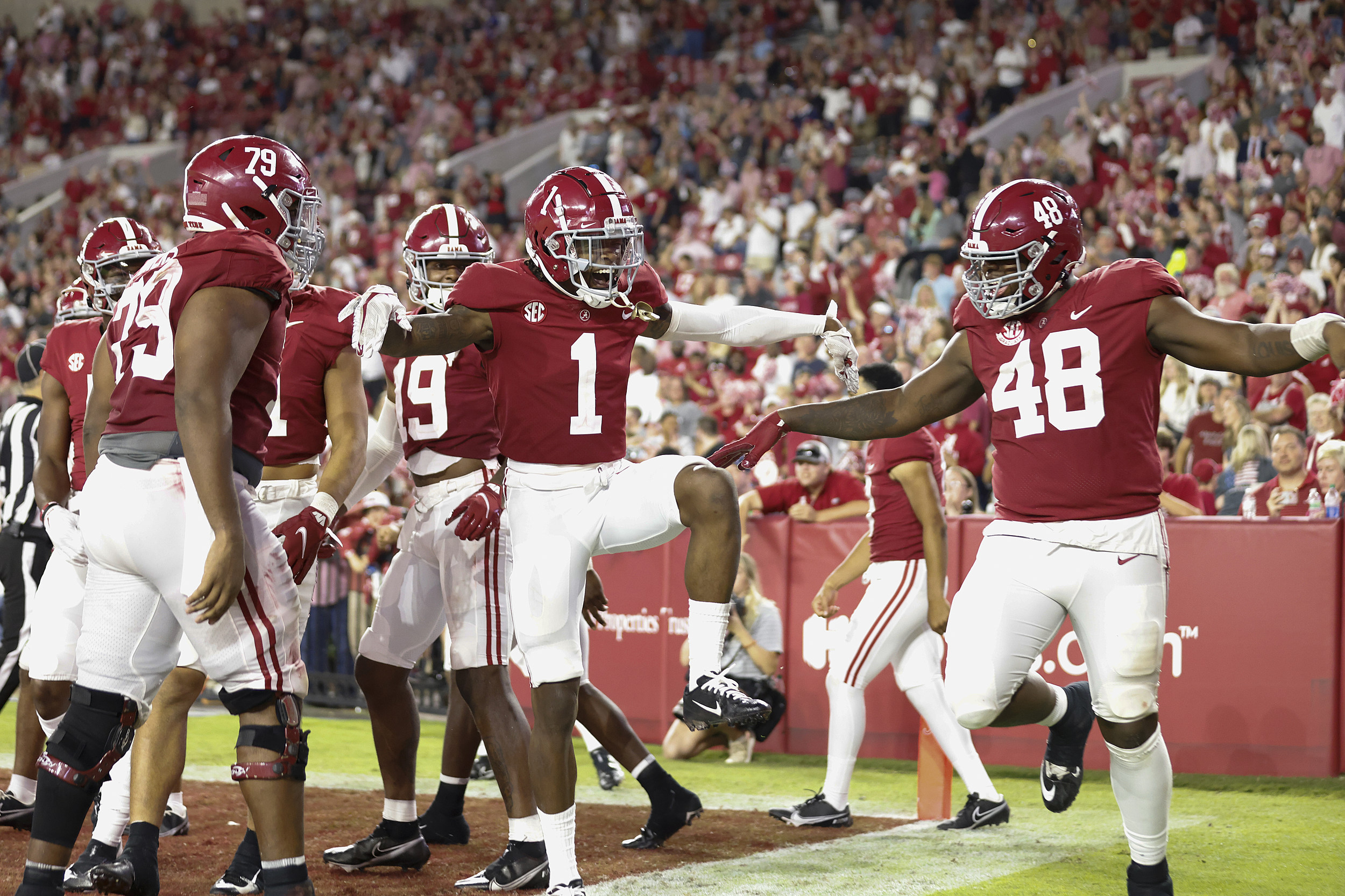 Alabama center Chris Owens (79), receiver John Metchie III (8