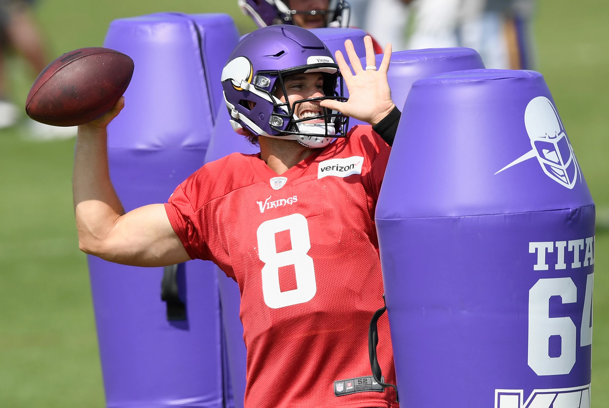 Minnesota Vikings quarterback Randall Cunningham waves to someone