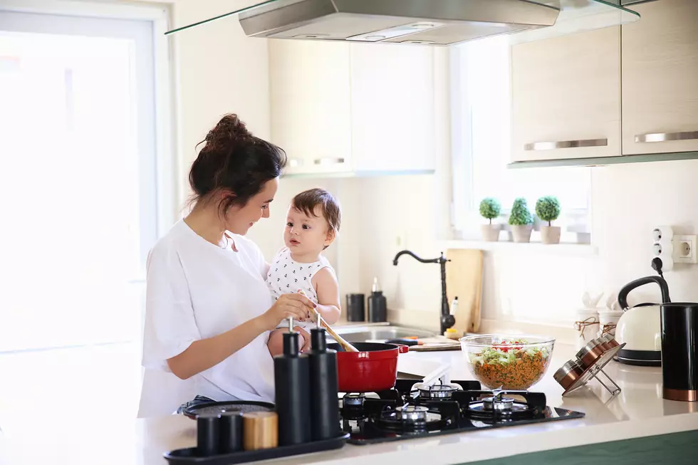 Mother of a woman with a baby cooks the food