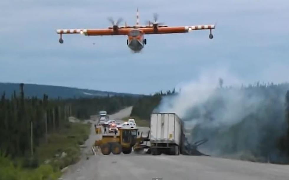 Water Bomber Swoops In To Put Out Highway Fire [VIDEO]