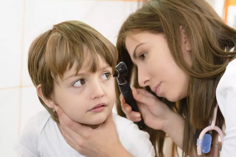 Otolaryngologist examining a kid ear in a clinic