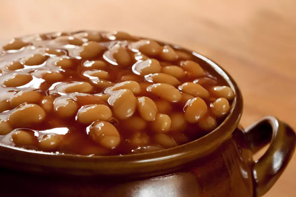 Baked beans in tomato sauce, in a brown pot.