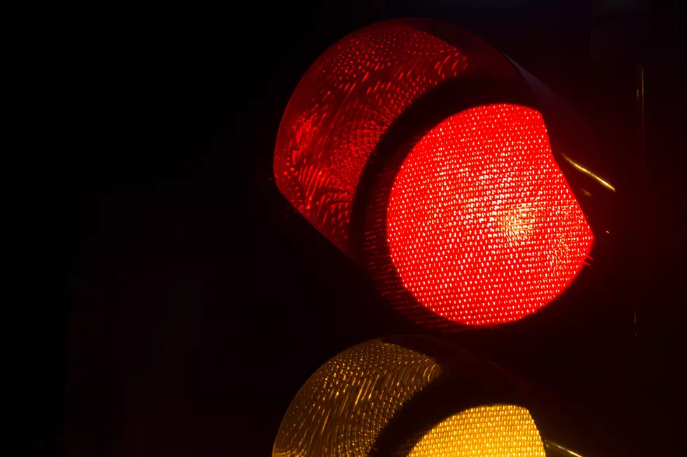 Closeup of a traffic light by night in Israel. Red light.