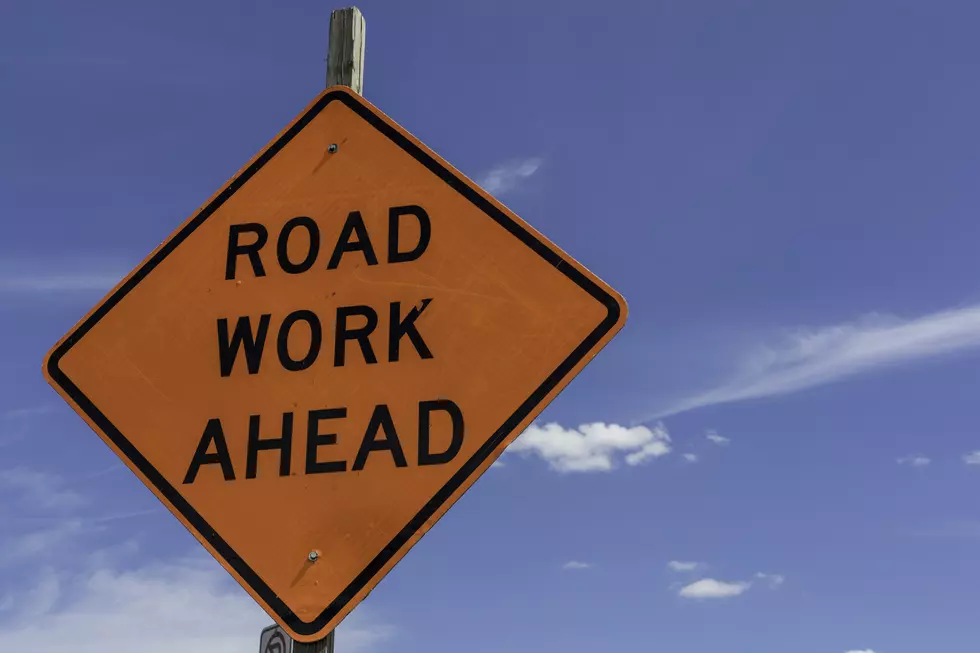 Road Work Ahead Sign shown against a bright blue sky