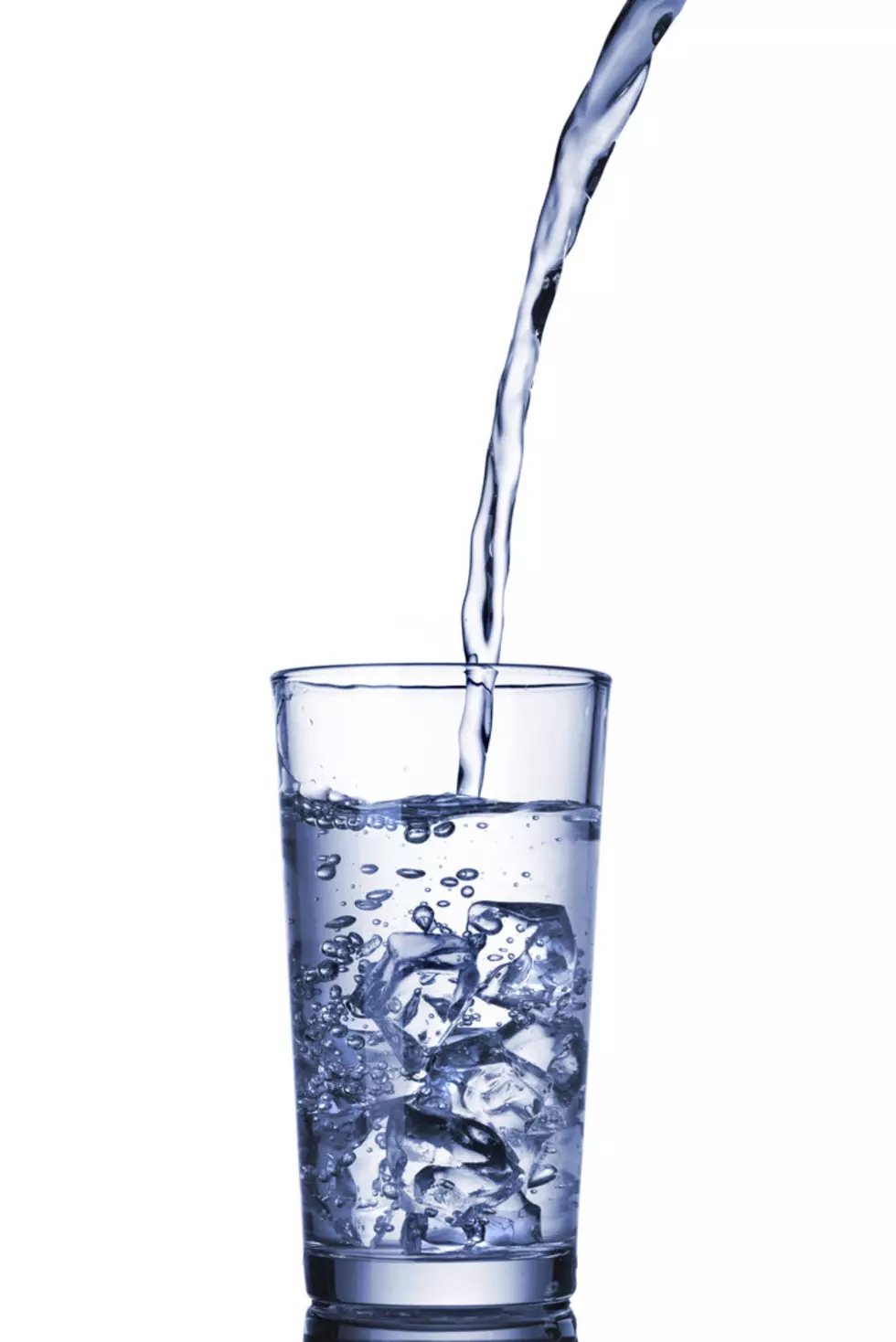 water pouring into glass isolated on white