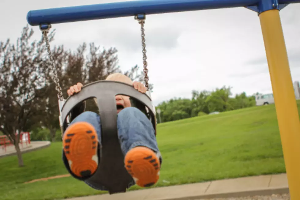 Grown El Pasoans Having Fun On A Baby Swing