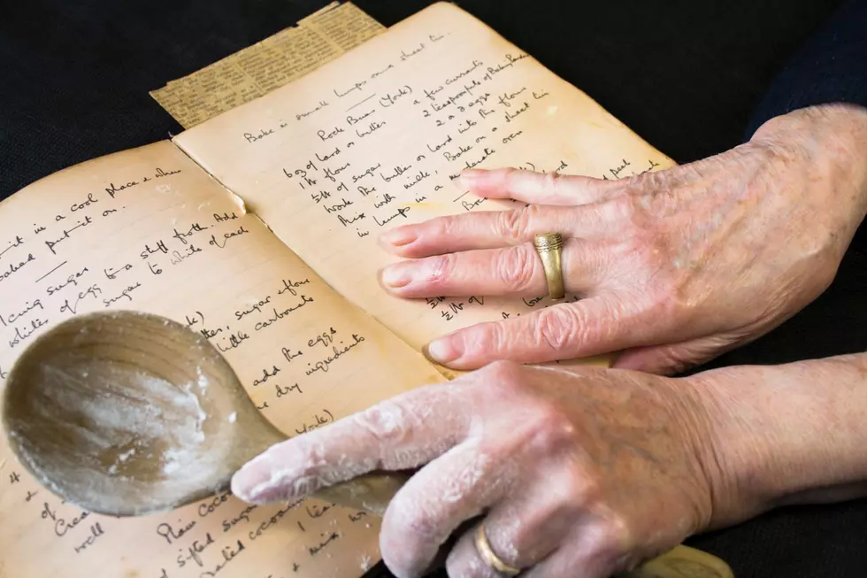 woman reads an old cook book