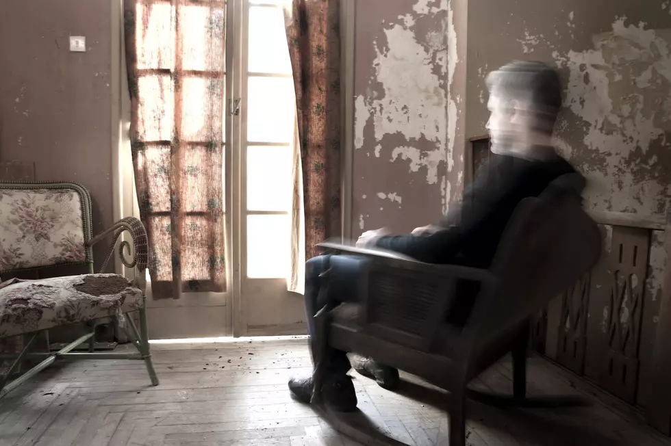 Man on rocking chair in a dirty old room