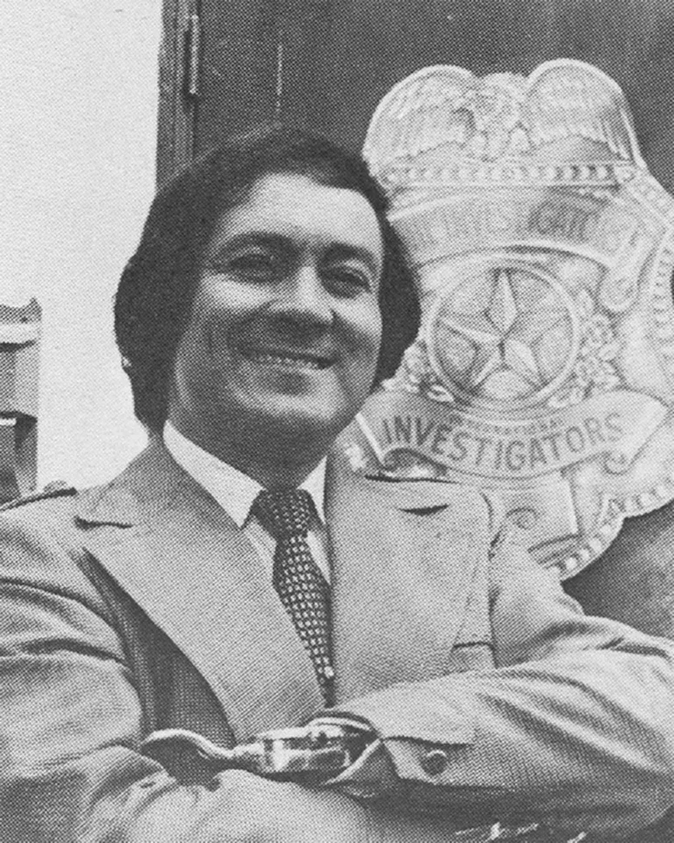 Jay J. Armes in front of The Investigators badge, El Paso Times Archive