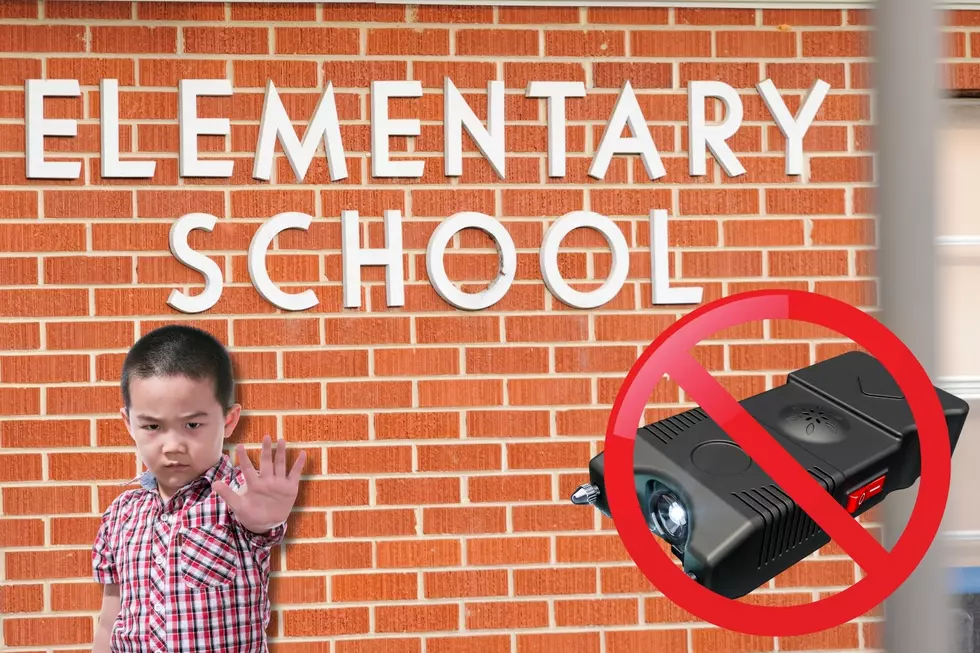 Kid holding up hand as 'no/stop' in front of elementary school; taser surrounded by 'NO' symbol