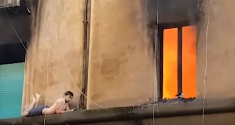 WATCH: Man Is Rescued From the Fourth Floor Ledge of a Burning Building