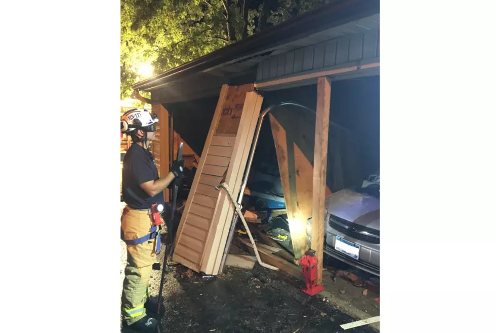 Car Drives Through Rochester Apartment Garage Building