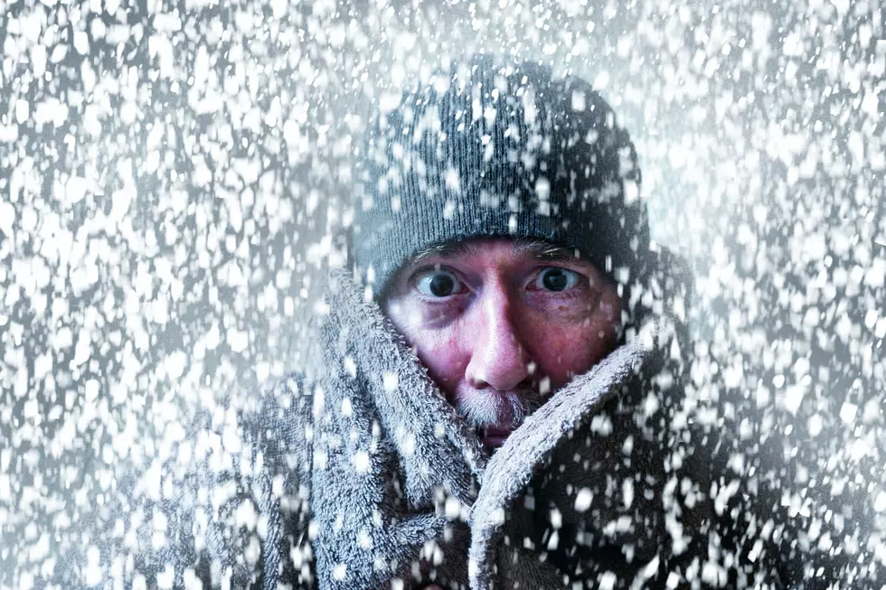 Wintery scene of a man shivering in a snow storm