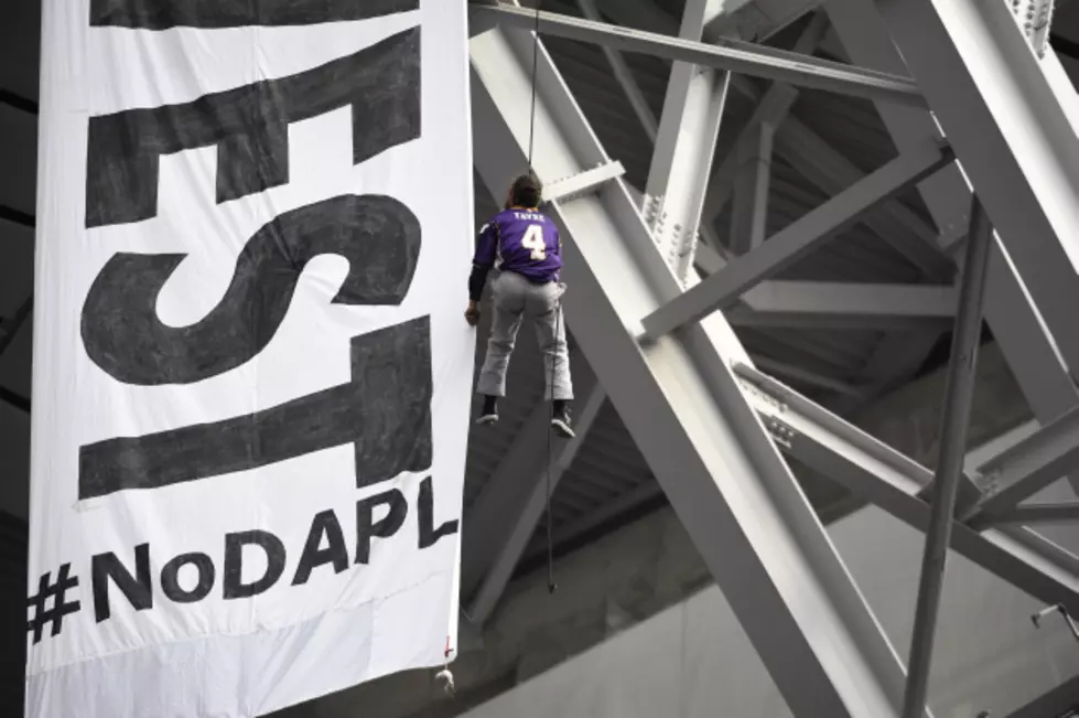 Oil Pipeline Protesters Unfurl Banner During Vikings Game