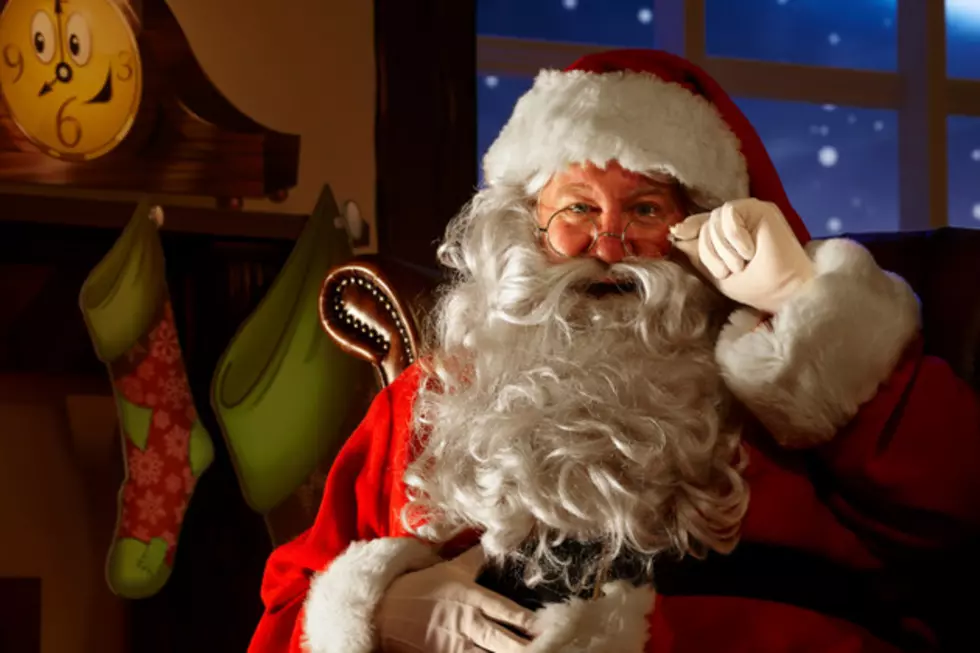 close up of happy Santa holding his glasses