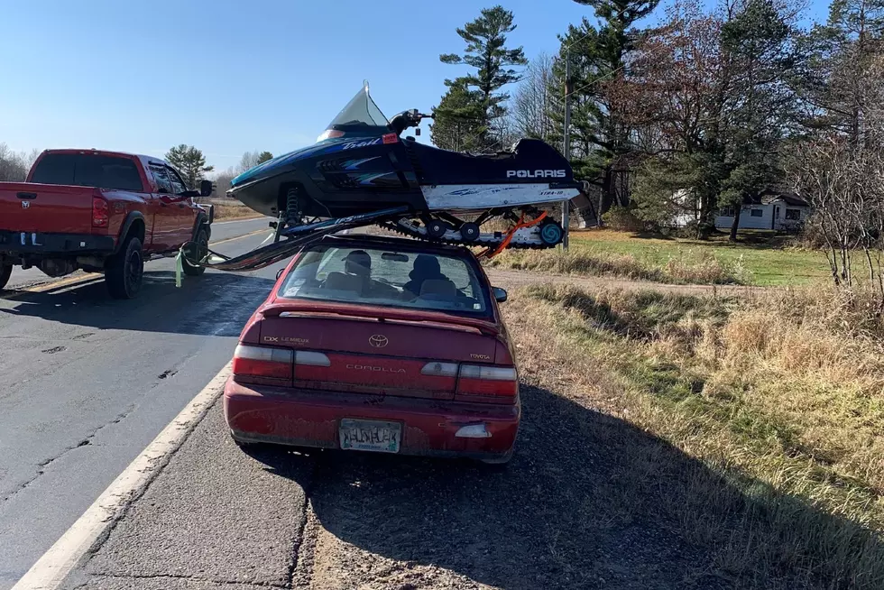 Trooper Stops Driver Hauling Snowmobile on Top of His Car