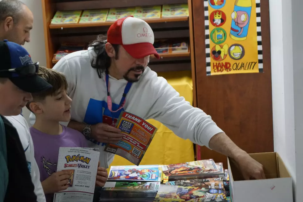 Michael Piza and his son Mason choosing free comics during 2025 Free Comic Book Day at Granite City Comic and Games, PHOTO by Paul Habstritt, WJON