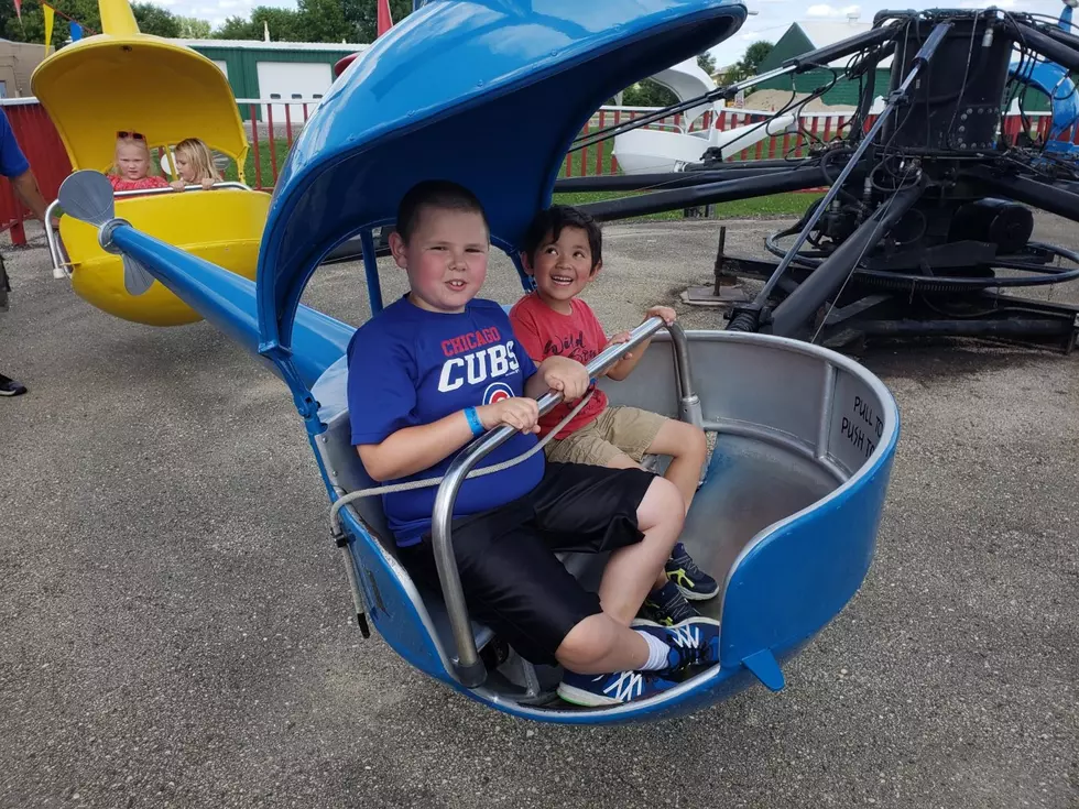 Jacob riding the helicopters with his cousin Bodhi