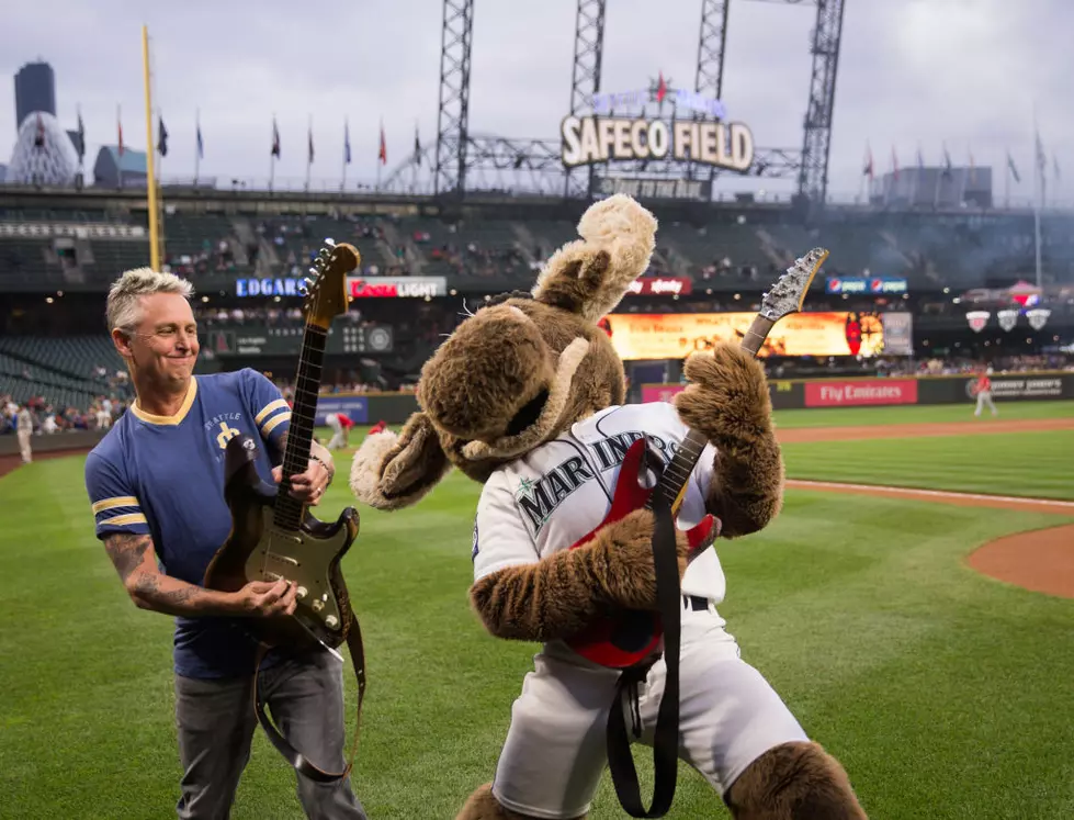 Mike McCready of the band Pearl Jam, poses for photos on the field after  performing the National Anthem before a baseball between the Chicago White  Sox and the Seattle Mariners on Friday