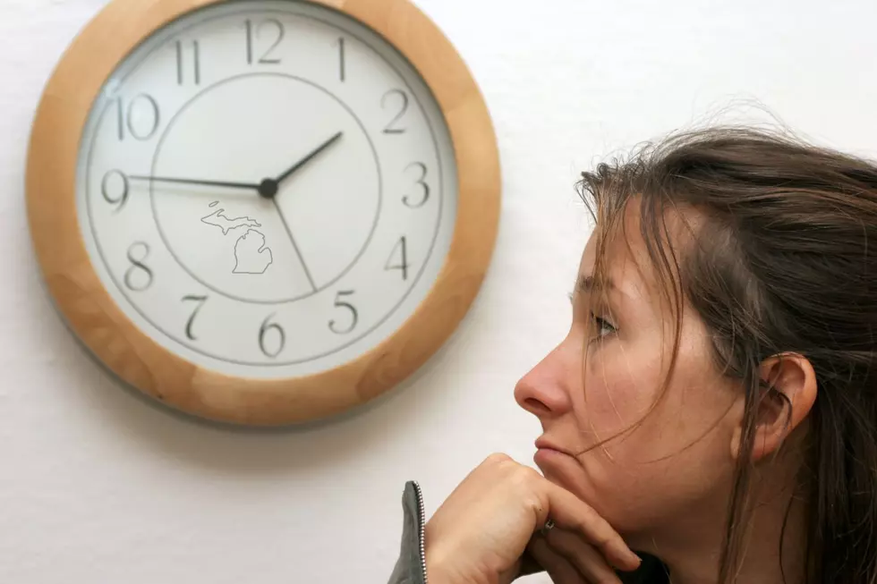 A woman watches the clock