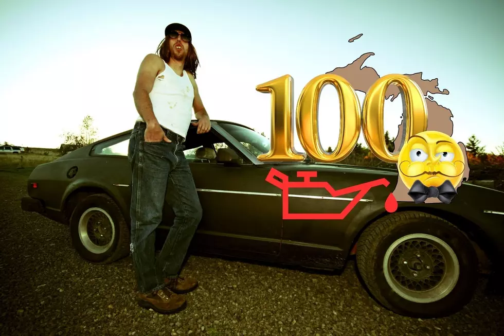 A man with a mullet leans against a late model muscle car that has seen better days. An outline of Michigan is also seen with a 100 graphic and a snobby cartoon face wearing a bowtie