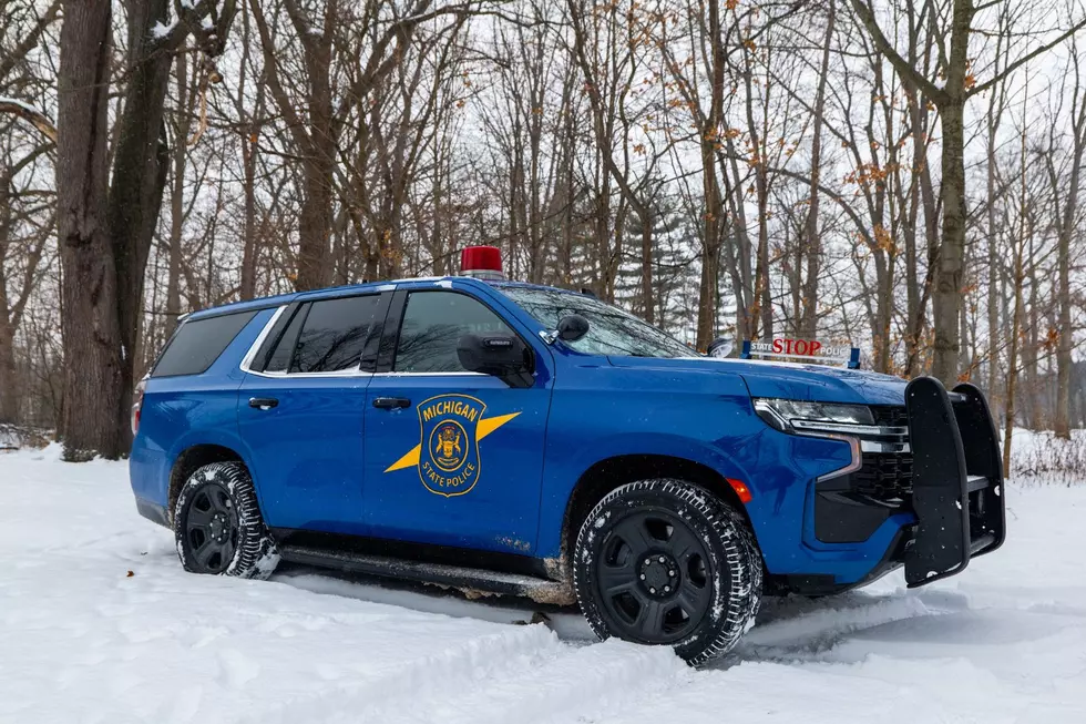 The iconic Michigan State Police cruiser with it's red bubble is seen traversing snow covered roads.