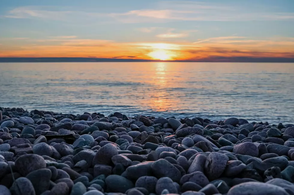 A rocky shoreline along Lake Superior at sunset