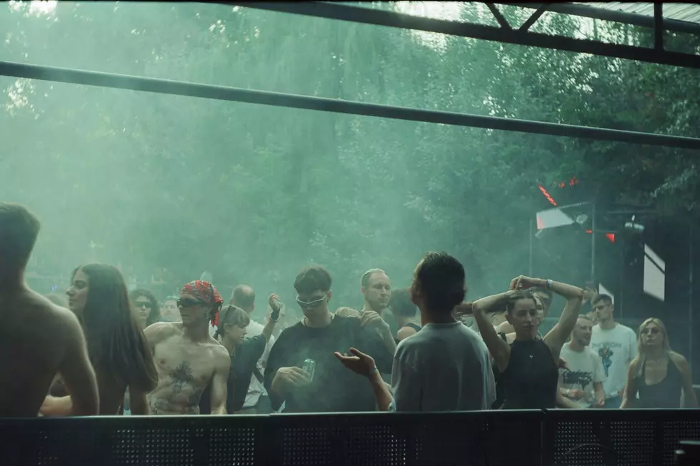 A group of concert goers being drenched in a downpour.