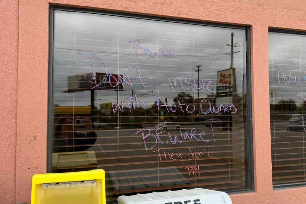 Flap Jack in Lansing near Frandor is still not open after fire, windows suggest owners and workers cannot return because insurance money isn't being paid out in a timely fashion - Flapjack windows with writing on them 1
