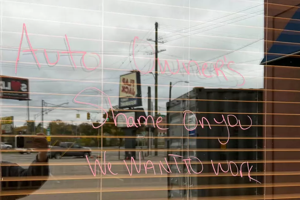 Flap Jack in Lansing near Frandor is still not open after fire, windows suggest owners and workers cannot return because insurance money isn't being paid out in a timely fashion - Flapjack windows with writing on them 6