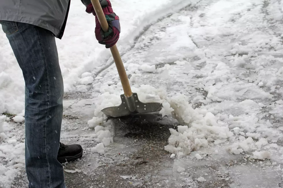 Man shoveling snow from this driveway or sidewalk