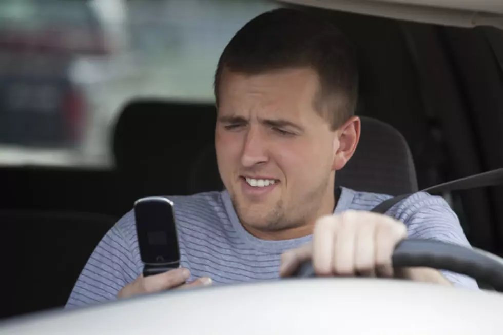Guy Is Driving While Looking At His Laptop, Cellphone, and Wearing Headphones [VIDEO]