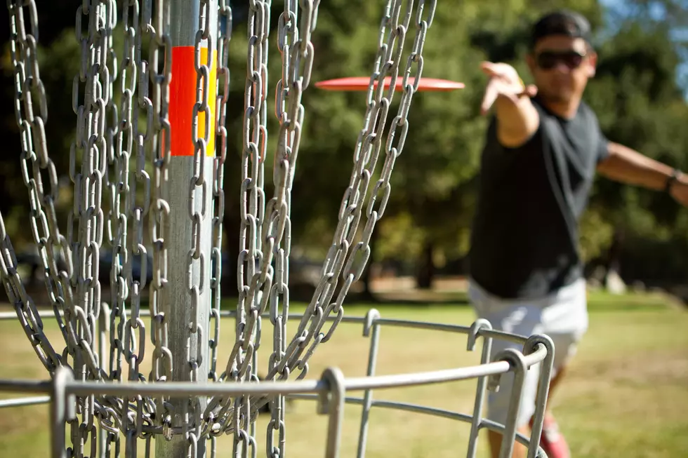 Disc golfer shows excellent form and release for ideal putting shot.