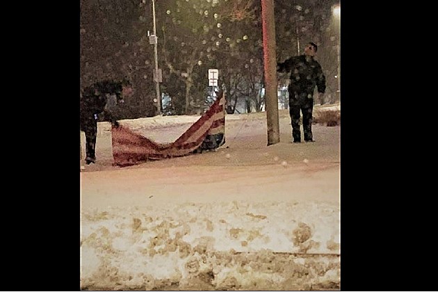 EMTs Pick Up Fallen American Flag During Snowstorm
