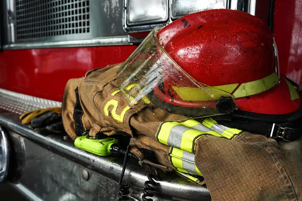 Firefighter protection gear, helmet, gloves on the bumper of the fire truck