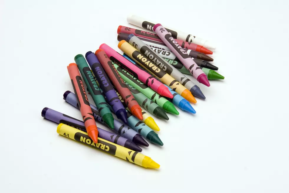 Multi Coloured Crayons set against a plain backgrund.