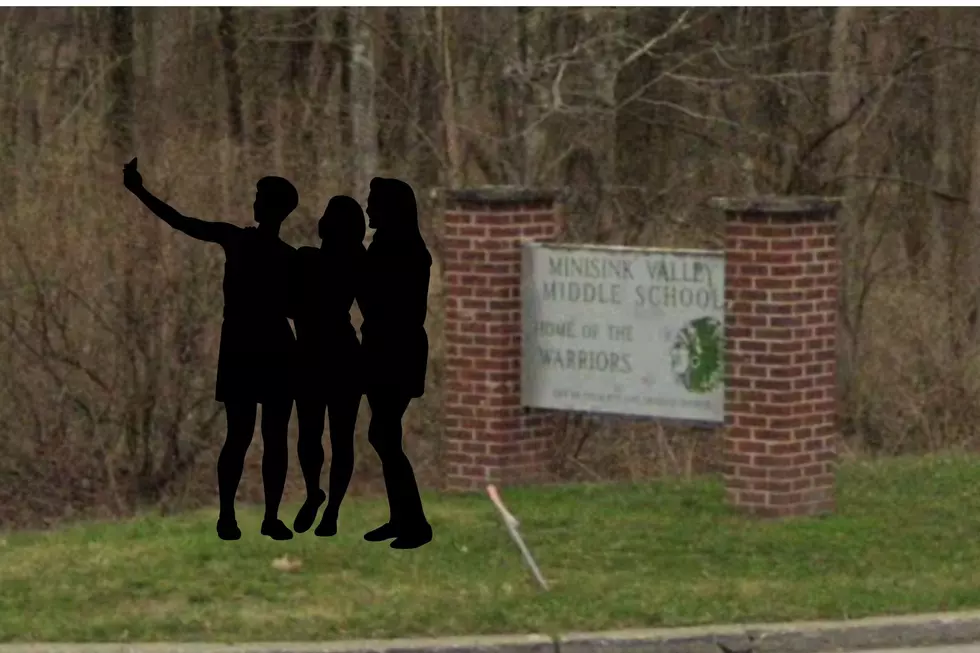 Why Are People Taking a Picture with a School Sign in Minisink