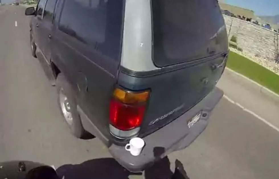 Motorcyclist Takes Full Coffee Mug From The Rear Bumper of a Moving Vehicle