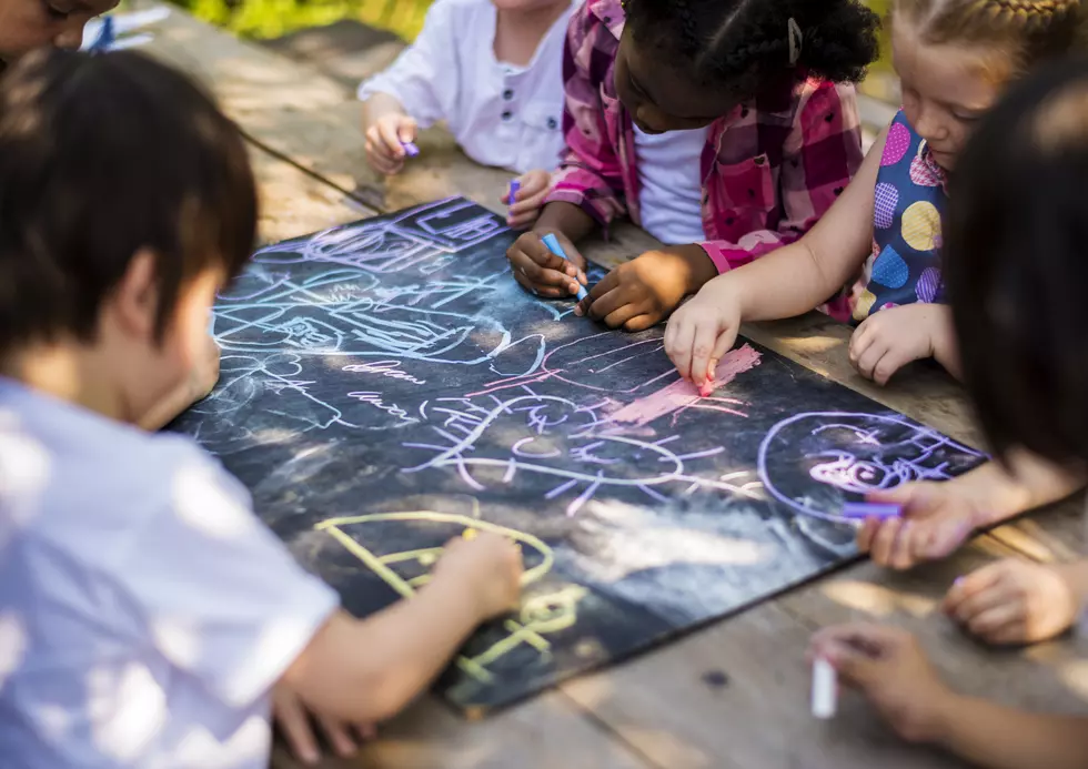 Children drawing art class outdoors