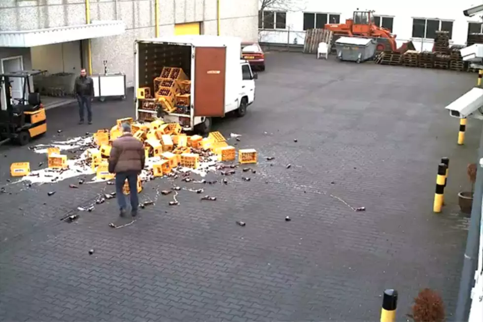 Workers Drop a Pallet Full of Beer Cases From Delivery Truck