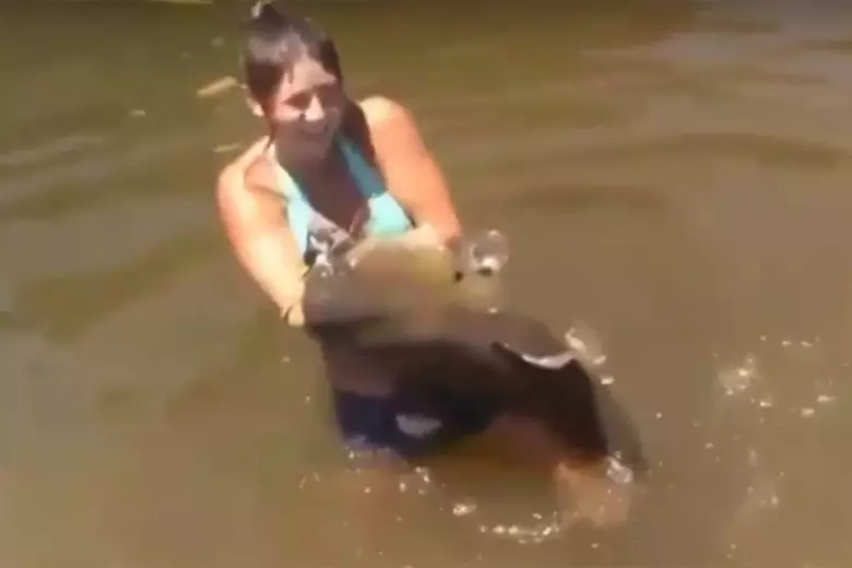 Bikini-Clad Girl Catches Huge Catfish Barehanded
