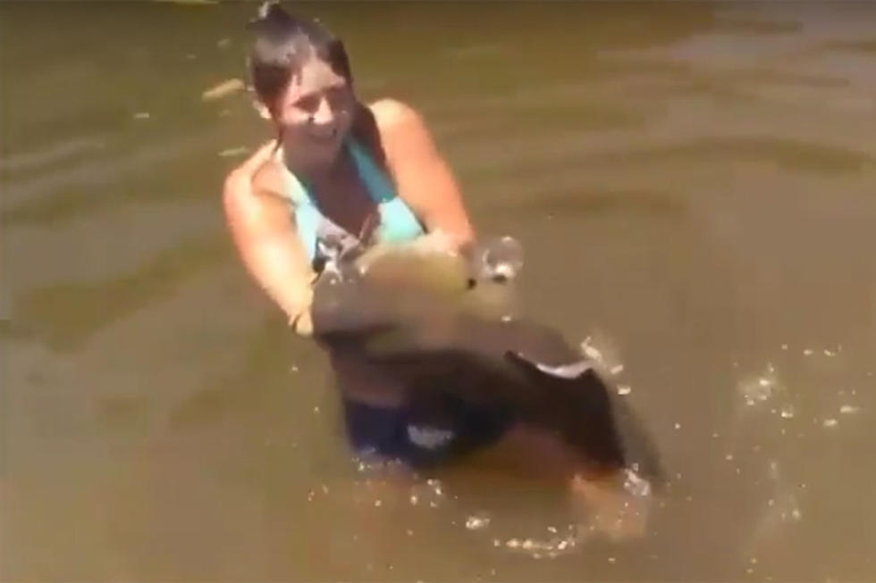 Bikini-Clad Girl Catches Huge Catfish Barehanded